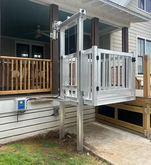 Outdoor platform lift for wheelchair access to a porch, showcasing a type of home elevator.