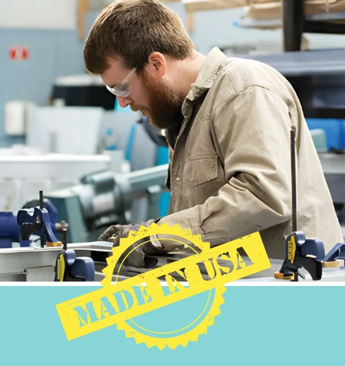 Manufacturer working with tools in a workshop, wearing safety glasses. "Made in USA" stamp in yellow, relevant to home elevators industry.